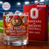 Whiskey glass and box show 135 years of Buckeye Football, 1890-2025, featuring the Ohio State logo and stadium design.!