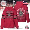 Front and back of a red Ohio State Buckeyes hoodie, showing a skull wearing a football helmet and bold text. Designed with sporty sleeve stripes and a thick, warm texture!