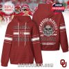 Crimson Oklahoma hoodie with front Sooners text and a fierce football skull on the back. Bold fan design and game-day style!