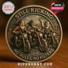 A detailed commemorative coin shows three joyful older men riding motorcycles through a scenic desert route. The engraved text includes STILL KICKING at the top and NO RULES, NO FILTERS at the bottom, highlighting the Route 66 theme.
