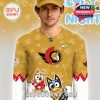 A person modeling a gold Ottawa Senators jersey covered in playful cartoon dog artwork and team logos.