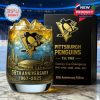 A Pittsburgh Penguins anniversary whiskey glass with gold blue design ice filled drink and matching black collector box!