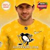 Close up of yellow hockey jersey and cap with Penguins logo and smooth mesh texture!