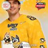 Side view of yellow hockey jersey with Bluey Night graphics and subtle paw print pattern!