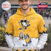 Yellow hockey hoodie with Penguins logo and cartoon characters worn by a smiling male model outdoors!