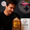 A close-up of a man with a Steelers whiskey glass in front of a collector box. The glass is filled with a dark drink and features stadium engravings and Terrible Towel graphics!