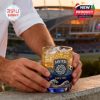 San Diego FC whiskey glass with ice and golden drink resting near a stadium during sunset viewed from close range!