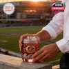 Glass with 'San Diego Aztecs' logo, Aztec warrior, and a football on a stadium background.!