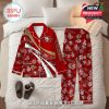 Red San Francisco 49ers pajama set with floral accents and custom name text, arranged on a neatly made bed for a cozy, inviting feel!