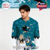 Male model wearing a teal and white San Jose Sharks jersey with Bluey characters.