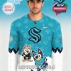 Man wearing a teal Seattle Kraken hockey jersey with Bluey and Bingo characters, team logo, and snow-themed design!