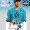 Man facing camera while wearing teal NHL Kraken Bluey jersey, decorated with cartoon and team elements in a playful winter style!