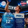 Stadium celebration captured as a fan proudly lifts his drink in Seahawks spirit, featuring a glowing blue whiskey glass and anniversary packaging!