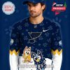 Side shot of man wearing the navy St. Louis Blues Bluey jersey with playful winter design and NHL branding!