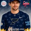 Zoomed-in image of man wearing festive navy hockey jersey with Blues logo, paw prints, and Bluey patch on the arm!