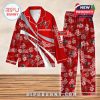 A red Tampa Bay Buccaneers-themed pajama set with floral designs, silver diagonal stripes, and custom name placement, shown on a wooden floor background!