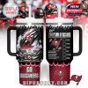 A 40oz tumbler with dual handles and a straw lid, themed with Tampa Bay Buccaneers branding. The design includes a fiery football entering a stadium scene, team name, and logo. Red burst background and fan silhouettes add energy and movement!