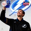Smiling man raising Tampa Bay Lightning 36th anniversary glass in front of a giant illuminated logo!