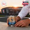 Close-up of hands holding a Tennessee Titans whiskey glass filled with ice in front of Nissan Stadium at golden hour!