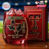 A detailed close-up of a red whiskey glass celebrating the Texas Tech Red Raiders 100th Anniversary, featuring gold logos, text, and decorative laurel leaves next to a matching box!