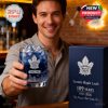 A Maple Leafs supporter presenting a branded whisky glass with blue ice and matching packaging in a relaxed bar environment!
