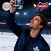 A celebratory moment showing a Toronto Maple Leafs whisky glass held up proudly in a hockey rink setting!