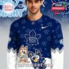 Man wearing a Toronto Maple Leafs Bluey Night hockey jersey in dark blue with cartoon characters and team logo!