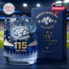Close-up image of a 115th anniversary Tar Heels whiskey glass and collector’s box, showcasing icy mountain graphics, gold typography, and the team’s iconic ram mascot!