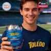 Young fan standing in the football stadium, smiling and presenting the limited Toledo Rockets glass with blue beverage and ice!