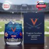 Blue-filled Virginia Cavaliers whiskey glass with ice and illustrated graphics of flowers, cardinal, and mountains next to a navy anniversary box, placed on a table at a sports stadium!