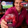 A man holding a UNLV Rebels anniversary whiskey glass forward in a lively sports bar setting!