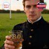 Man in military uniform standing in a field holding the VE Day 80th anniversary whiskey glass with “Lest We Forget” tribute!
