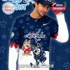 A man wears a navy and white long sleeve shirt decorated with cartoon characters Bluey and Bingo, the Washington Capitals hockey logo, and star and paw print patterns!