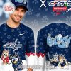 Front and back of a hockey-themed Bluey shirt showing Bluey and Bingo playing hockey, paired with the Washington Capitals logo and a navy pattern full of paw prints and stars!