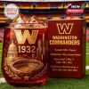 A rich red glass with the Washington Commanders logo and landmarks sits on a football field next to a detailed gift box honoring the team's founding and titles!
