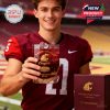 A smiling WSU football player displays a limited edition whiskey glass honoring the university’s legacy, emphasizing pride and tradition in a stadium environment!