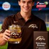 A fan holding a filled Western Michigan Broncos whiskey glass next to a logo box during a stadium event.