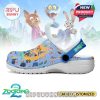 A cartoon-covered clog shoe with Zootopia 2 illustrations and adjustable strap for name personalization, placed in front of a playful animated poster!