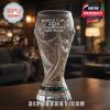 Empty World Cup trophy shaped glass on a bar table with engraved text World Cup 2026 Champions Are Made.