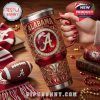 This premium Alabama tumbler is shown in a cozy fan setting, highlighting its large handle, rich red design, and football-themed engravings. It blends elegance with spirited team pride!