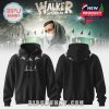Alan Walker in his signature hoodie from the Walkerworld Tour collection, standing against a forest backdrop.