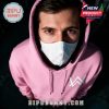 A person wearing a pink hoodie and mask with Alan Walker's logo.
