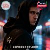 A person in a black hoodie with Alan Walker’s logo in a city at night.