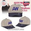 A two-tone baseball hat with AW initials embroidered in blue and orange on the beige crown, a navy blue curved bill, and a silver autograph stitched at the brim, perfect for Alex Warren supporters!