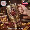 This detailed Yeti tumbler stands out with its ASU mascot centerpiece, bold gothic elements, and elegant gold handle. It blends seamlessly with a backdrop of university-themed accessories and rich wooden tones!