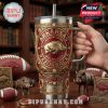 This Arkansas-themed Yeti tumbler stands out with its maroon backdrop, raised gold hog logo, and gemstone styling. Surrounded by sports gear and mascots, it captures the power and pride of Razorbacks fans!