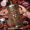 This close-up shows the Auburn Tigers-themed Yeti tumbler being held, set against a vibrant football fan backdrop with school colors, gear, and festive decorations, capturing the energy of game day!