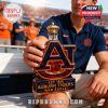 A fan holding the Auburn Tigers Whiskey Bottle during the game, showcasing the golden crown and bold Auburn logo.