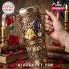 A romantic themed tumbler held in hand, decorated with Beauty and the Beast characters and surrounded by vintage books and candlelight.