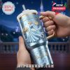 Cinderella anniversary tumbler held in hand with castle in background.